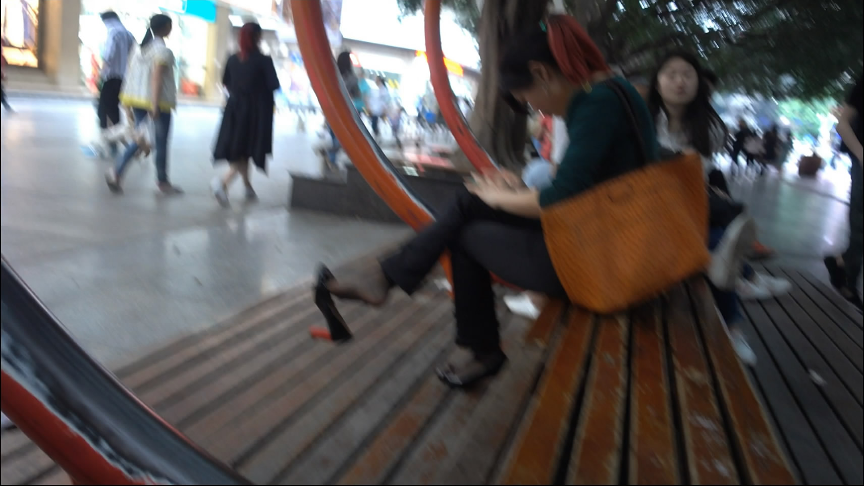 Busy dangling woman in cellphone on public space